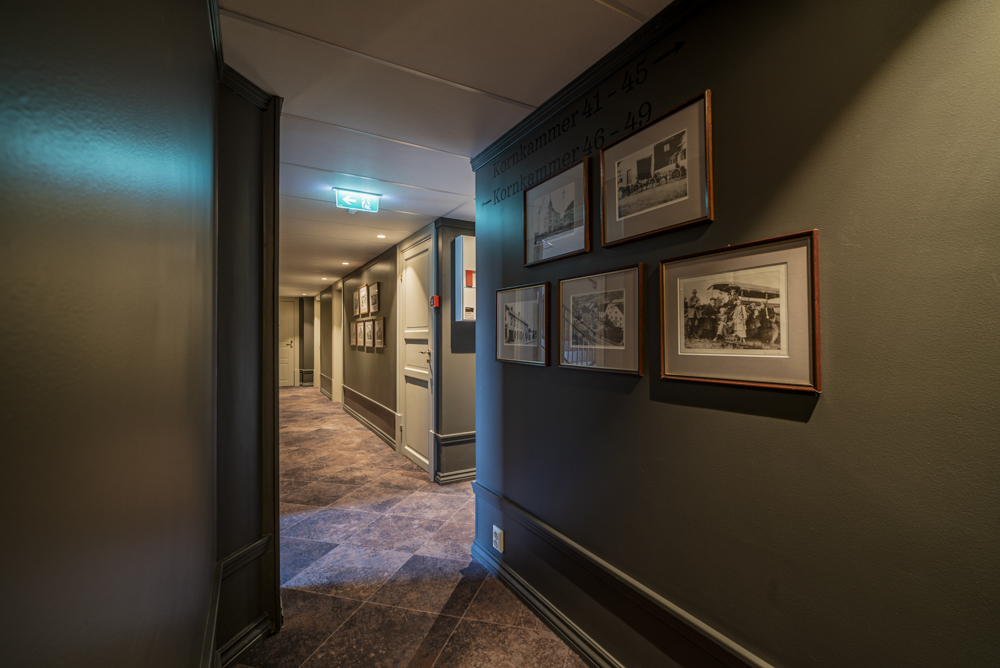 Hotel corridor adorned with historical pictures.